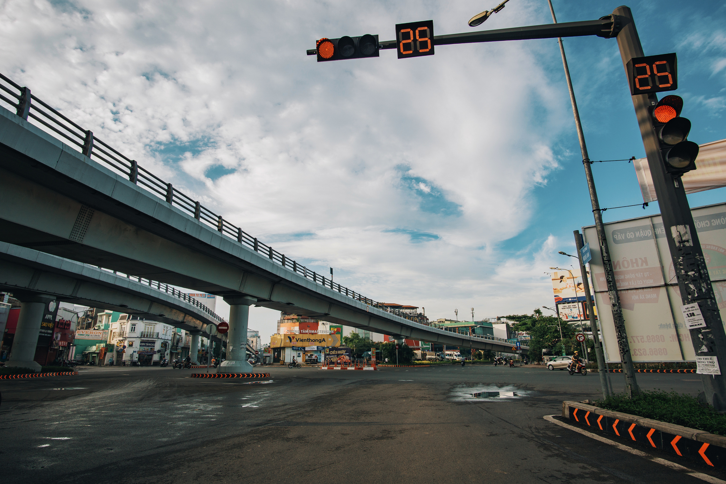 Road with red traffic light under bridge